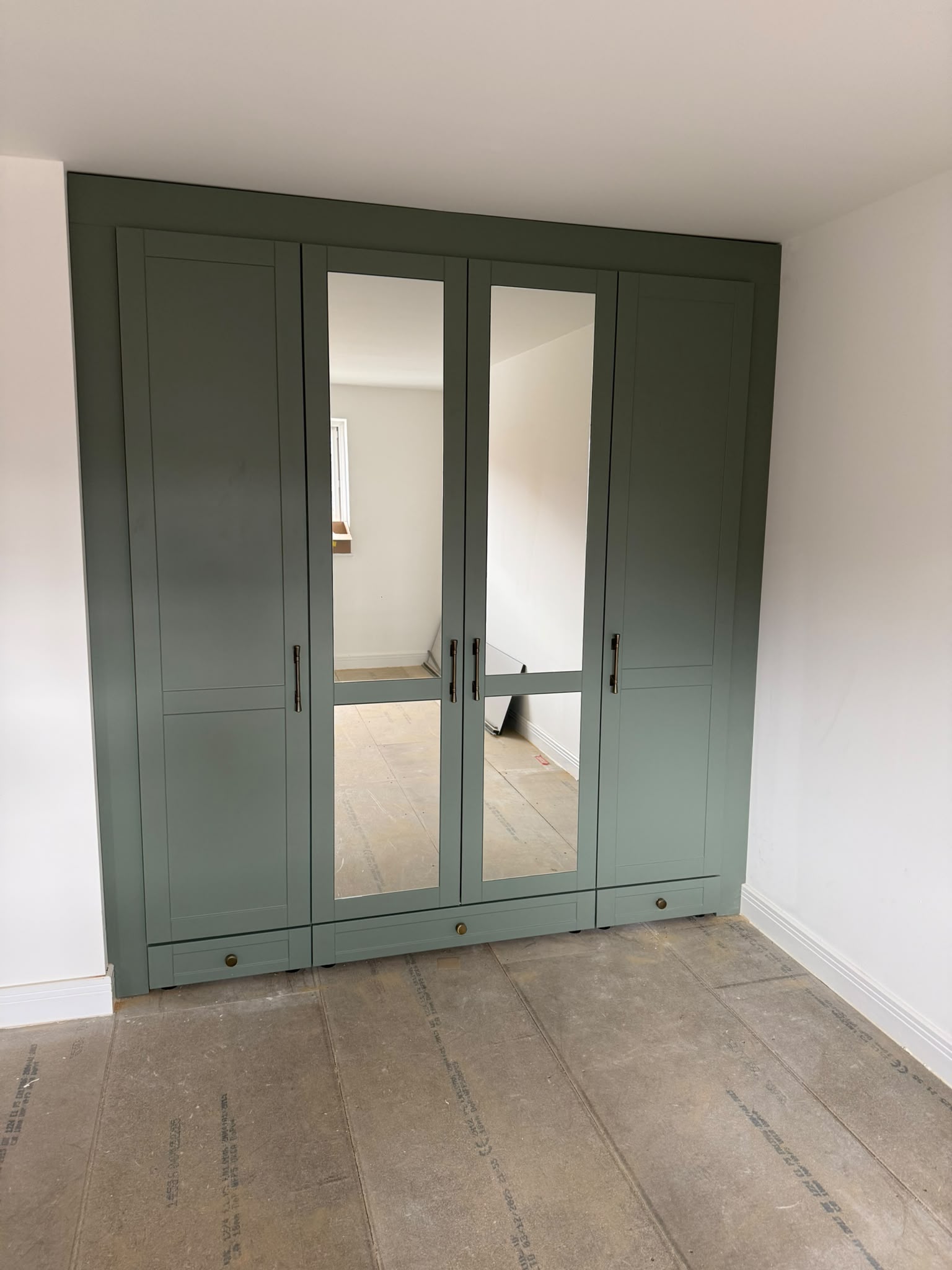 Bespoke fitted wardrobes with mirrored doors in a Newcastle bedroom
